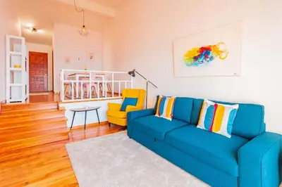 a living room with a blue couch and a yellow chair at FLH Funchal Ocean View with Pool in Funchal