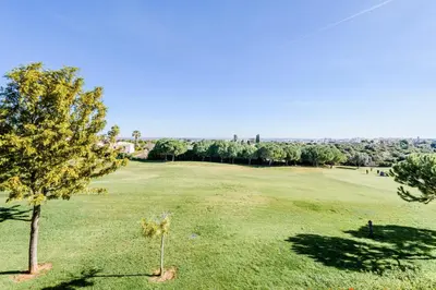 a green field with a tree in the middle at Boavista Golf Resort- Fairviews Villa in Lagos