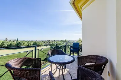 a patio with chairs and a table on a balcony at Boavista Golf Resort- Fairviews Villa in Lagos