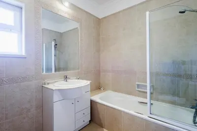 a bathroom with a tub and a sink and a shower at Boavista Golf Resort- Fairviews Villa in Lagos