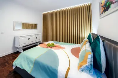 a bedroom with a large bed with a sqor sqor at Sea Breeze II in Caniço