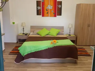 a bedroom with a bed with a flower on it at Tabua Village Madeira in Ribeira Brava