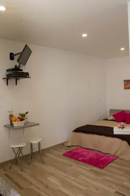 a bedroom with a bed with a camera on the wall at Tabua Village Madeira in Ribeira Brava
