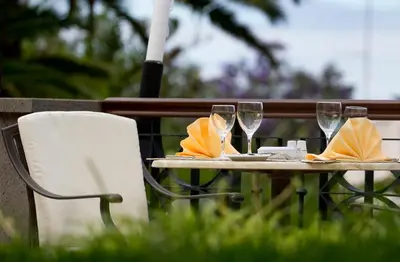 a table with wine glasses and napkins on it at Hotel Quinta Bela S Tiago in Funchal