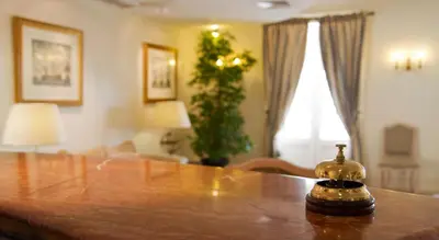 a dining room table with a bottle on top of it at Hotel Quinta Bela S Tiago in Funchal