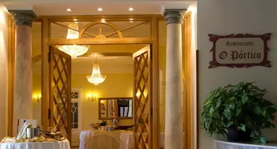 a dining room with a mirror and a table at Hotel Quinta Bela S Tiago in Funchal