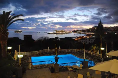 a view of a pool with a view of the water at Hotel Quinta Bela S Tiago in Funchal