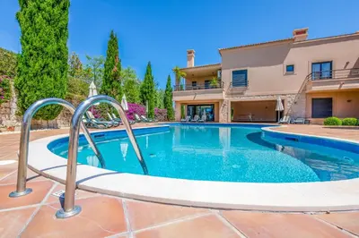 a swimming pool in front of a house at Mar da Luz Resort in Luz