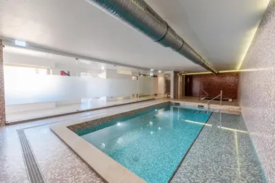 a large swimming pool in a building at Mar da Luz Resort in Luz