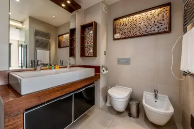 a bathroom with a tub and a toilet and a sink at Mar da Luz Resort in Luz