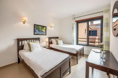 a hotel room with two beds and a window at Mar da Luz Resort in Luz