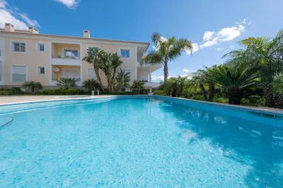 a large swimming pool in front of a building at Porto de Mós 72 by Destination Algarve in Lagos