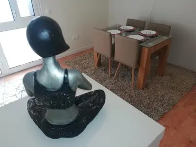 a statue of a person sitting on a table in a living room at Madeira House in Calheta