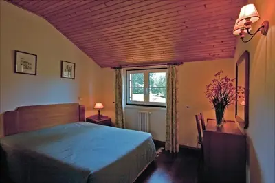 a bedroom with a blue bed and a window at Quinta das Colmeias in Santo da Serra