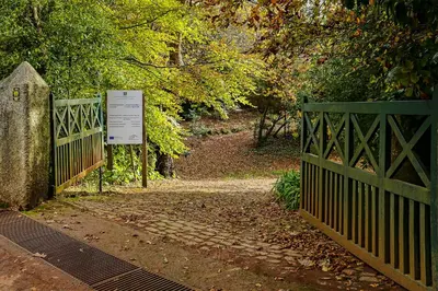 a gate to a park with a sign on it at Quinta das Colmeias in Santo da Serra