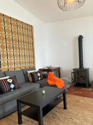 a living room with a couch and a stove at Casa da praia in Aljezur