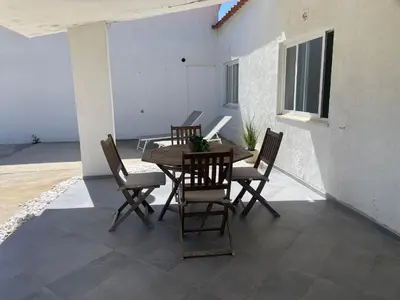 a dining room with a wooden table and chairs at Casa da praia in Aljezur