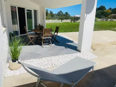 a dining room with a table and chairs at Casa da praia in Aljezur