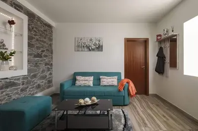 a living room with a blue couch and a table at Casa Tiana Madeira in Ponta do Sol