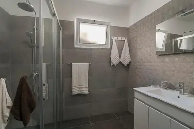 a bathroom with a shower and a sink at Casa Tiana Madeira in Ponta do Sol