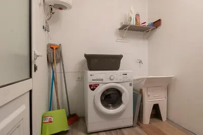 a laundry room with a washing machine in it at Casa Tiana Madeira in Ponta do Sol