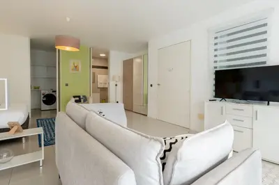 a living room with a couch and a tv at The Little Nest by LovelyStay in Ponta do Sol
