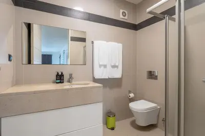 a bathroom with a toilet and a sink and a mirror at The Little Nest by LovelyStay in Ponta do Sol