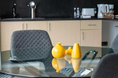 a glass table with yellow vases on top of it at The Little Nest by LovelyStay in Ponta do Sol