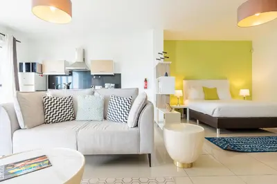 a living room with a couch and a bed at The Little Nest by LovelyStay in Ponta do Sol