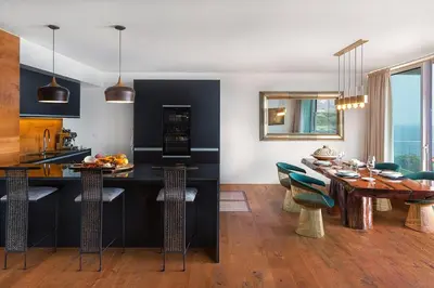 a kitchen and dining room with a table and chairs at Fazendinha by Real Vision in Gaula