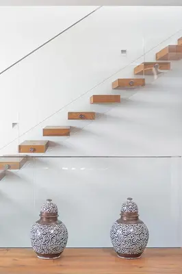 two vases sitting on a table next to a staircase at Fazendinha by Real Vision in Gaula