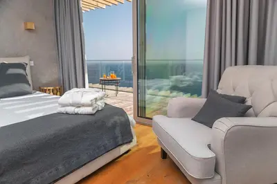 a bedroom with a bed and a chair and a window at Fazendinha by Real Vision in Gaula