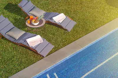 an overhead view of a pool with chairs and a table at Fazendinha by Real Vision in Gaula