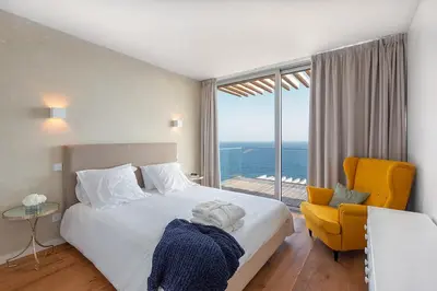 a bedroom with a bed and a chair and a window at Fazendinha by Real Vision in Gaula