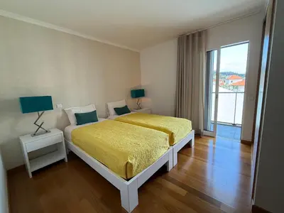 a rainbow in the sky over a city at Tamariz Adventure - Sea View and Free Parking in Caniço