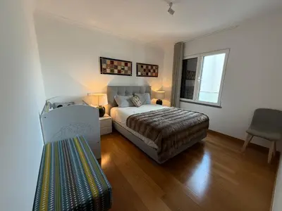 two beds sitting next to each other in a bedroom at Tamariz Adventure - Sea View and Free Parking in Caniço