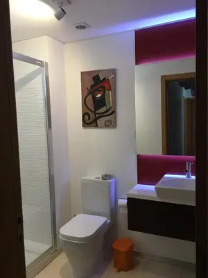 a bathroom with a toilet and a sink at Tamariz Adventure - Sea View and Free Parking in Caniço