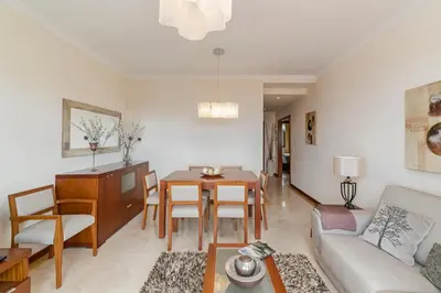a living room with a couch and a dining room at Ajuda III by An Island Apart in Funchal