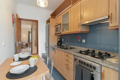 a kitchen with wooden cabinets and a counter top at Ajuda III by An Island Apart in Funchal