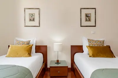 two beds sitting next to each other in a room at Ajuda III by An Island Apart in Funchal