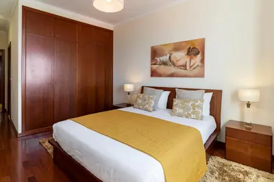 a bedroom with a bed and a painting on the wall at Ajuda III by An Island Apart in Funchal