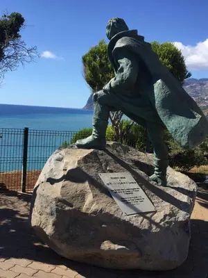 a statue of a man sitting on a rock at Ocean Dream Apartment- Air Condition in Funchal