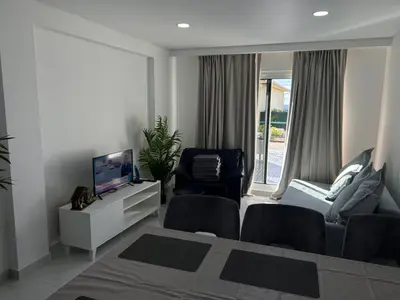a living room with a bed and a tv and a chair at Ocean Dream Apartment- Air Condition in Funchal
