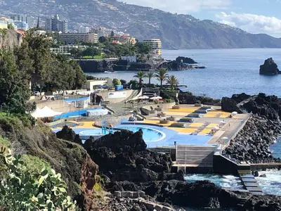 a group of swimming pools next to the ocean at Ocean Dream Apartment- Air Condition in Funchal
