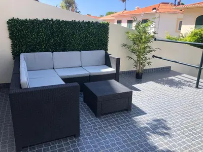 a couch and a stool on a patio at Ocean Dream Apartment- Air Condition in Funchal