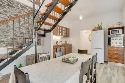 a kitchen and dining room with a table and chairs at Casa D`Avó Celina in Funchal