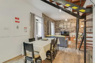 a kitchen and dining room with a table and chairs at Casa D`Avó Celina in Funchal