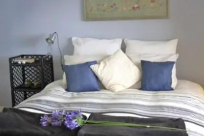 a bed with blue and white pillows on it at Apartment W Stunning View - MARINA - Free Parking & AC in Funchal