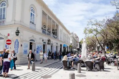 a group of people sitting outside of a building at Apartment W Stunning View - MARINA - Free Parking & AC in Funchal