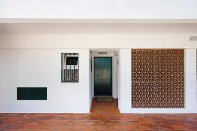 a view of the entrance to a building with a blue door at Apartamento Navegador in Sagres